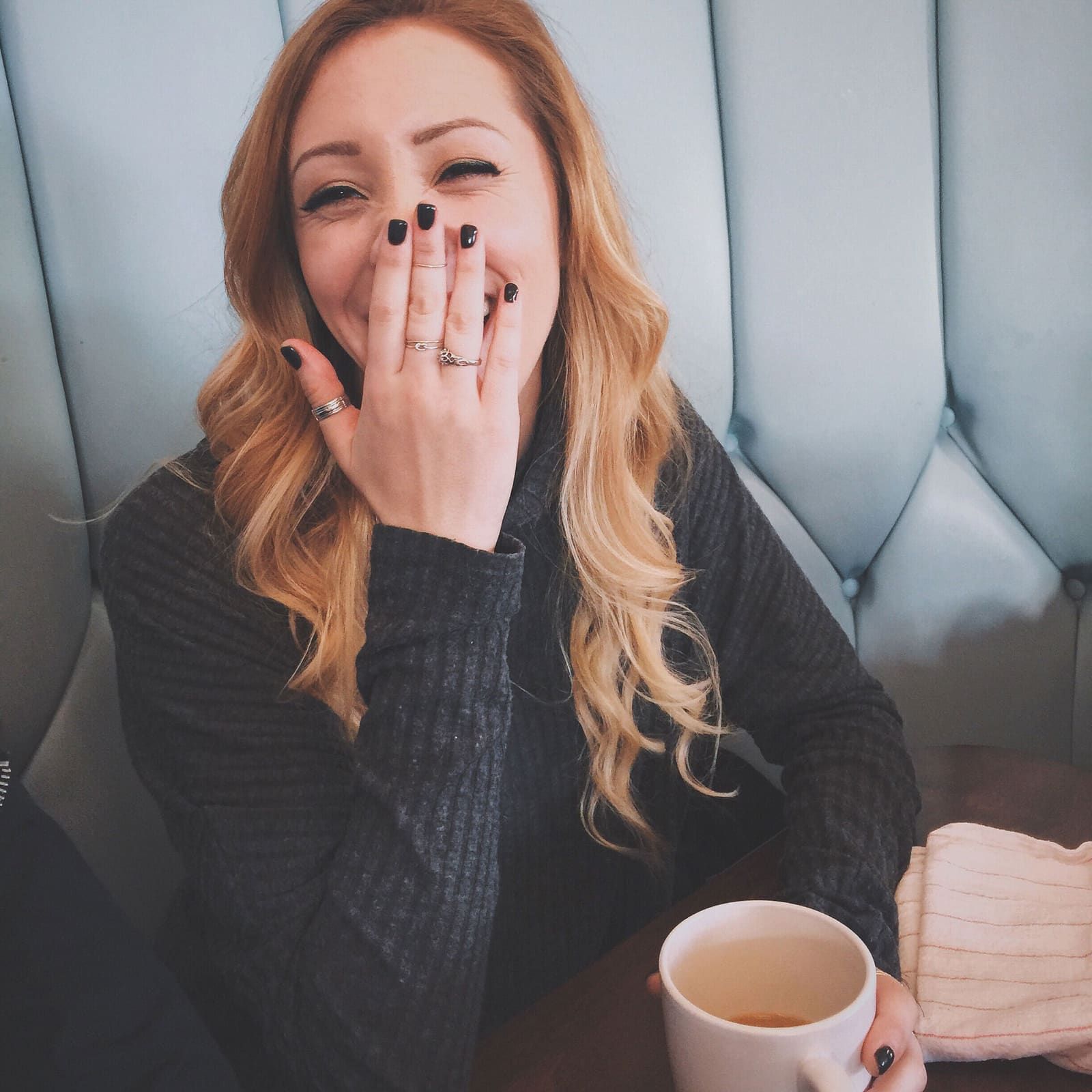 a woman with her hands on her face